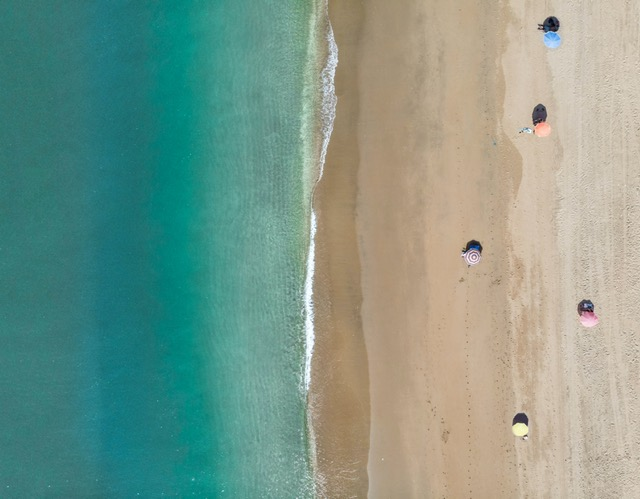 Social distancing at a beach last summer. Photo courtesy of Victor Garcia on Unsplash.