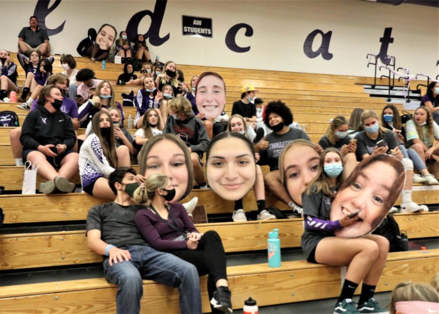 A-West fans gather on Tuesday night with giant posters to celebrate the seniors at the varsity girls volleyball game. 