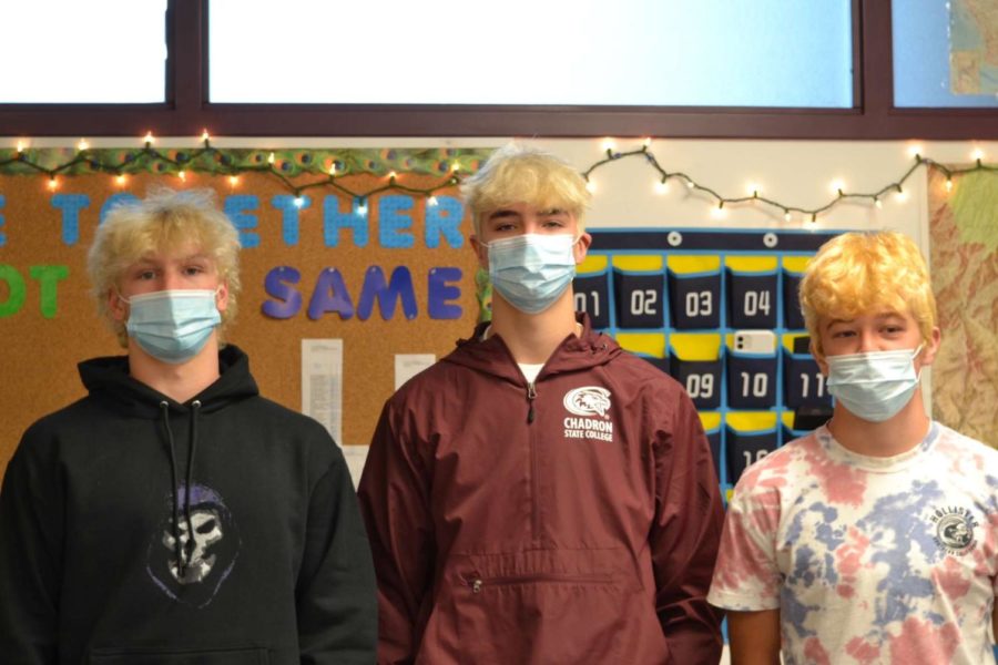 Junior football players, Charlie Smith, Brady Witherspoon and JT Nash showing off their blonde hair  