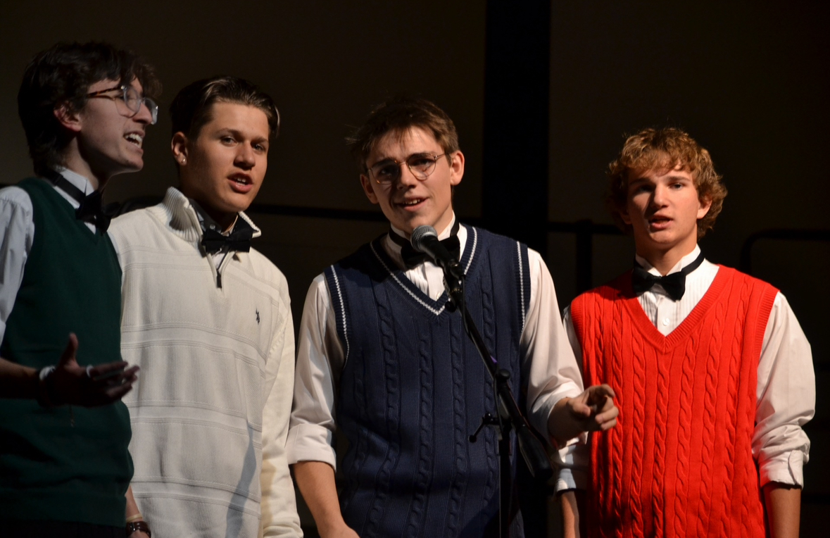 Portie, farthest right, performs in Mantastic Four at the annual Holiday Collage in 2023.